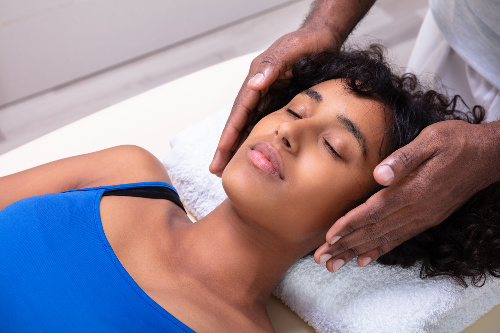 Person deeply relaxing as she receives Reiki.  Sekhem Seichem Reiki also lays the groundwork to encourage deep relaxation often having the ability to go deeper if needed.